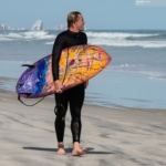 Surfer walking the beach
