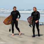Two Surfers walking on the beach
