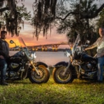Men riding Harley Davidson Suzuki at Sunset