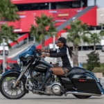 Women riding Harley Davidson 103 on road