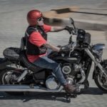Man riding Indian Motorcycle on road